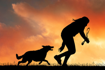 girl runs at sunset with dog