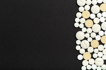 tablets and pills on dark background