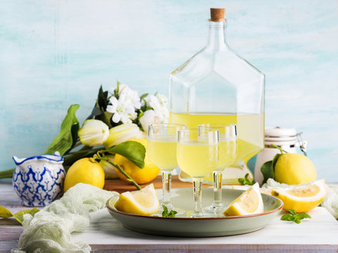 Home made limoncello served in stemmed glasses. Summer still life