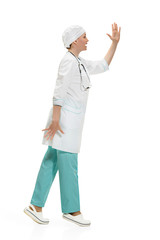 Beautiful young woman in white coat posing at studio. Full length studio shot isolated on white.