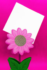 Flower shape paper holder with blank stickers with copy space for text, message or drawing on pink background as colorful template for mothers, fathers, valentines, wedding or birthday greeting card.