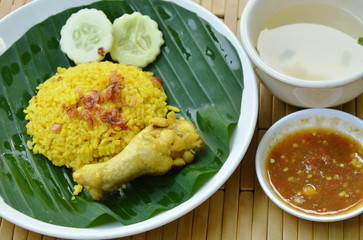 rice cooked with chicken in curry on plate and soup cup