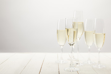 closeup shot of champagne glasses on white wooden table