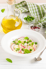 Salad with couscous, green peas, mozzarella and radish