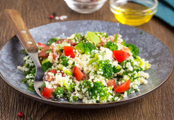 Salad with couscous, tomatoes, broccoli, tabbouleh