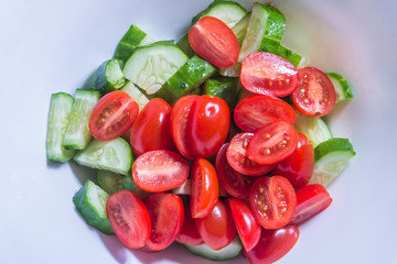 cucumbers and tomato salad on white plate