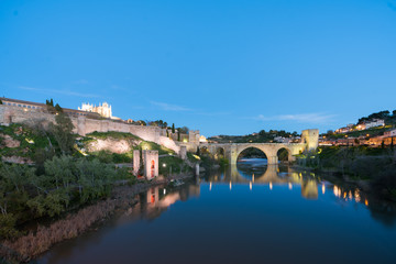 Naklejka premium Panoramic cityscape of Toledo with San Martin's Bridge at night near Madrid, Spain