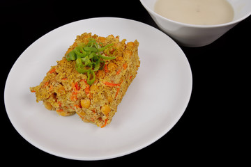 Polenta with poppy and vegetables on a table
