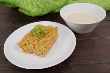 Polenta with poppy and vegetables on a table