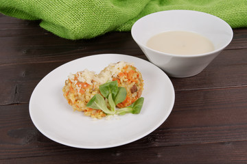 Risotto with carrot and cheese on table