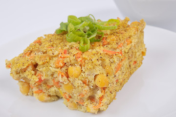Polenta with poppy and vegetables on a white