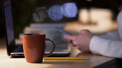Woman using smartphone, communicating with friends in social media on gadget