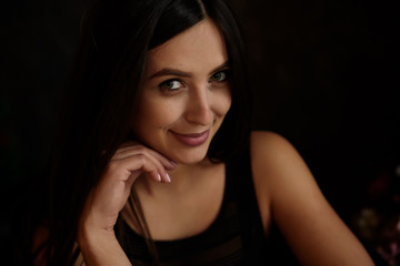 Beauty portrait of young adorable fresh looking brunette woman with long brown healthy curly hair.