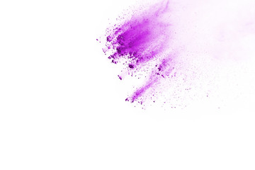 Powder explosion. Closeup of a purple dust particle explosion isolated on white. Abstract background.