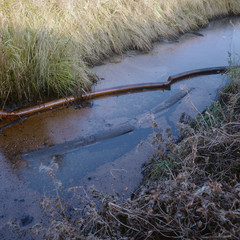 Waterway polluted with oil and chemicals after spill, Barking, East London, UK