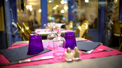 Upside down glasses on fashionably served table in modern restaurant, closeup