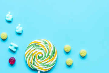 sweets and sugar candies on blue background top view mock-up