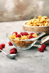 Bowl of Cornflakes and Raspberries for a healthy breakfast concept