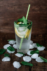 Glass of lemonade on a wooden background