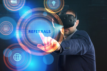 Business, Technology, Internet and network concept. Young businessman working in virtual reality glasses sees the inscription: Referrals