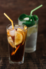 Two glasses of lemonade on a wooden background