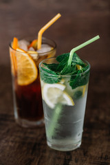 Two glasses of lemonade on a wooden background
