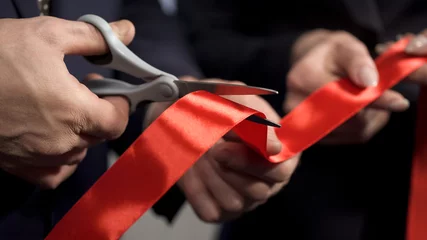 Foto op Canvas Business people hands cutting red ribbon close-up, new project, opening ceremony © motortion
