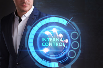 Business, Technology, Internet and network concept. Young businessman working on a virtual screen of the future and sees the inscription: Internal control