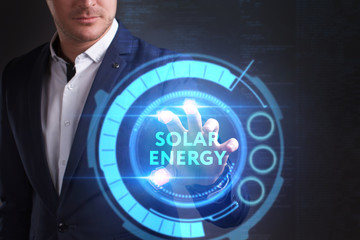 Business, Technology, Internet and network concept. Young businessman working on a virtual screen of the future and sees the inscription: Solar energy