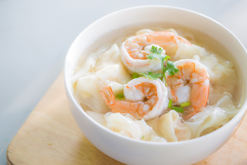 Selective focus/Shrimp Wonton and prawn on bamboo grille and wooden table.
