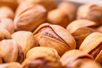 Close-up of pistachio. Selective focus on foreground.Pistachios texture. Nuts. Roasted salted pistachio nuts healthy delicious food studio photo.