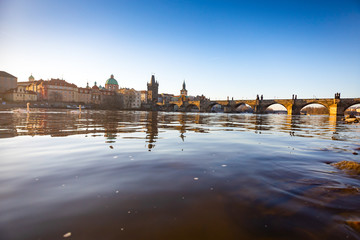 Charles Bridge and river Vltava at sunrise light in early morning