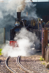 Departure of a steam locomotive in a cloud of smoke and steam