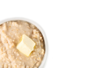 Fototapeta na wymiar breakfast: oatmeal porridge with butter in white bowl on white background. Top view. Isolated