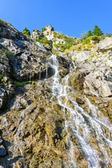Daylight view to waterfall on the side of road
