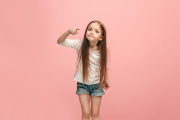 Beautiful female half-length portrait on pink studio backgroud. The young emotional teen girl