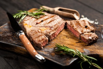 Grilled steak on wooden cutting board
