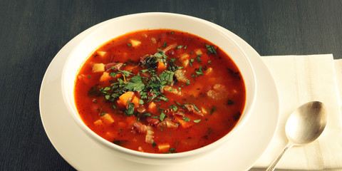 Tomato soup with red beans, potato and carrot. Vegan diet. European cuisine. Vegetarian dish. Main course. Organic meal. Wide photo.
