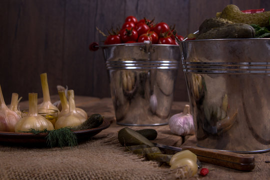 Cucumbers with garlic and tomatos in the bround background