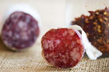 slice of hot salami with crushed hot pepper