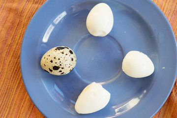 hard boiled quail eggs put on a blue dish