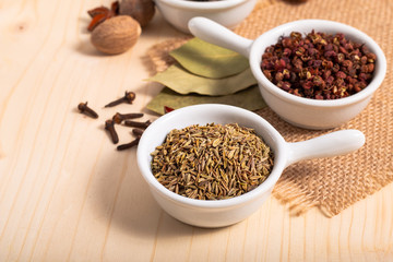 Exotic spices concept Chinese Asian Spices mix cumin seeds, Sichuan peppercorns, star anise pods, bay leave, black peppers, nutmegs, cloves with copy space