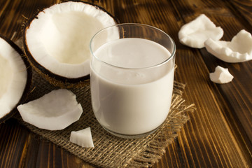 Coconut  milk in the glass on the rustic wooden  background