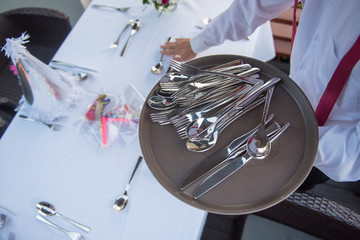 The restaurant staff is preparing the equipment on the table.