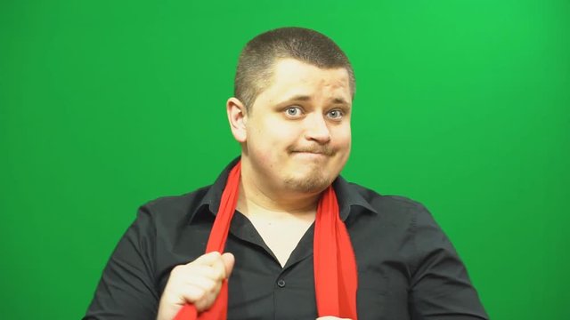 Young man posing. Good mood. Performs arbitrary rhythmic movements. Background green screen.