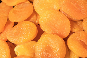 Heap dried apricots close up as background. 