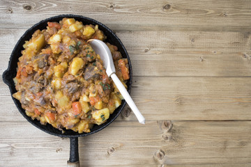 stewed vegetables with beans and meat in a frying pan