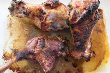 Appetizing grilled turkey shanks and chicken legs