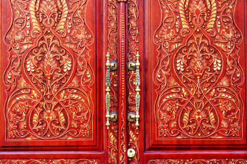 doors are made of mahogany and patterns on them