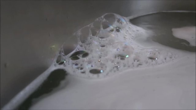Foam bubbles in a stainless steel sink
